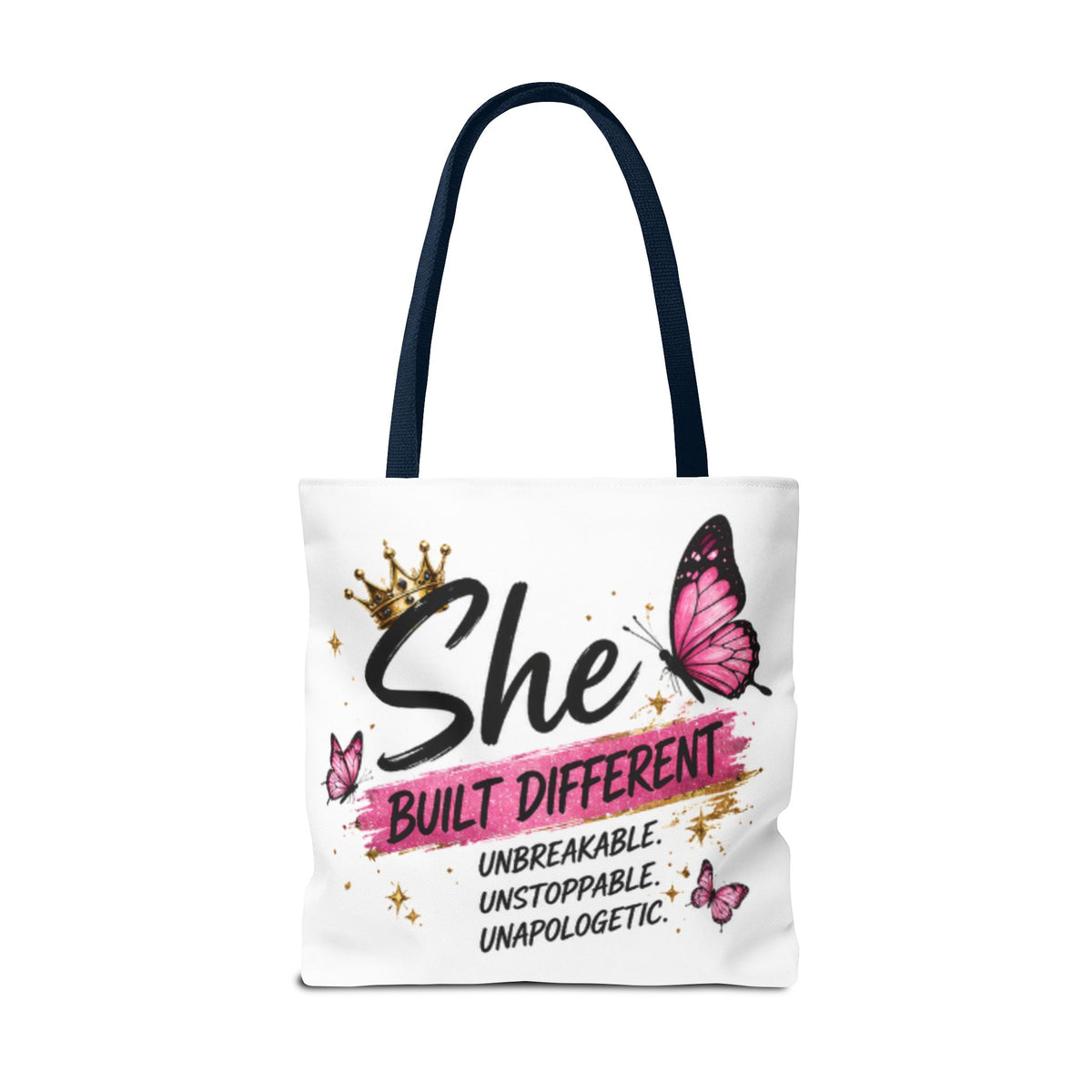 White canvas tote bag with navy handles, pink butterfly “She built different” artwork
