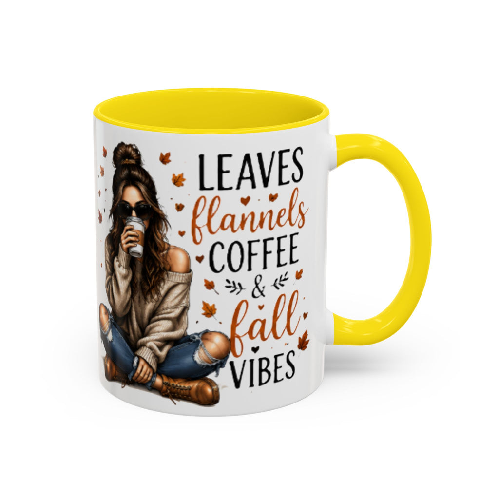 White ceramic coffee mug with yellow handle and interior, “Leaves flannels coffee & fall vibes”