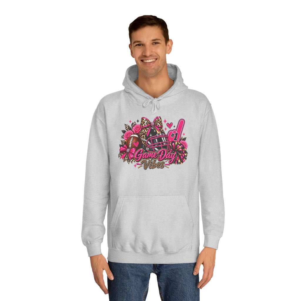 Game Day Cheer Hoodie — Pink Football Floral Design by Printify, gray pullover hoodie modeled by a man with a pink football, helmet, flowers, pom poms, and Game Day graphic