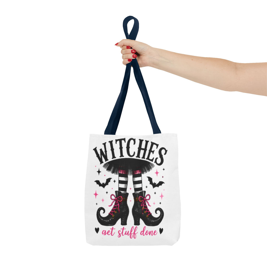 White tote bag held by top handle with “WITCHES” and witch boots graphic
