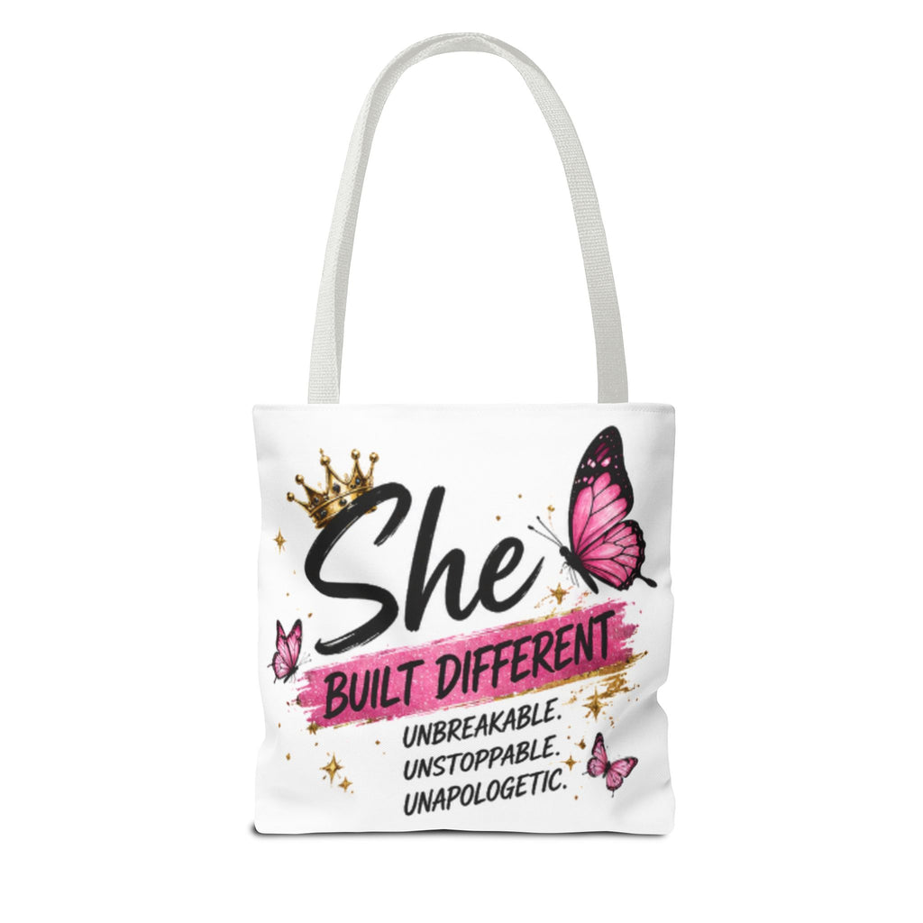 White tote bag with light gray handles, “She Built Different” butterfly graphic centered.