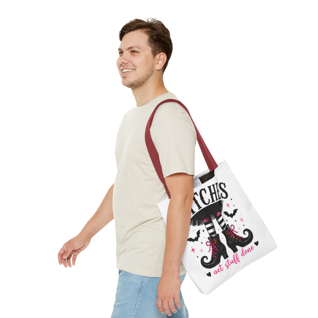 White tote bag with burgundy handles and witch boots graphic, front view with full lettering.