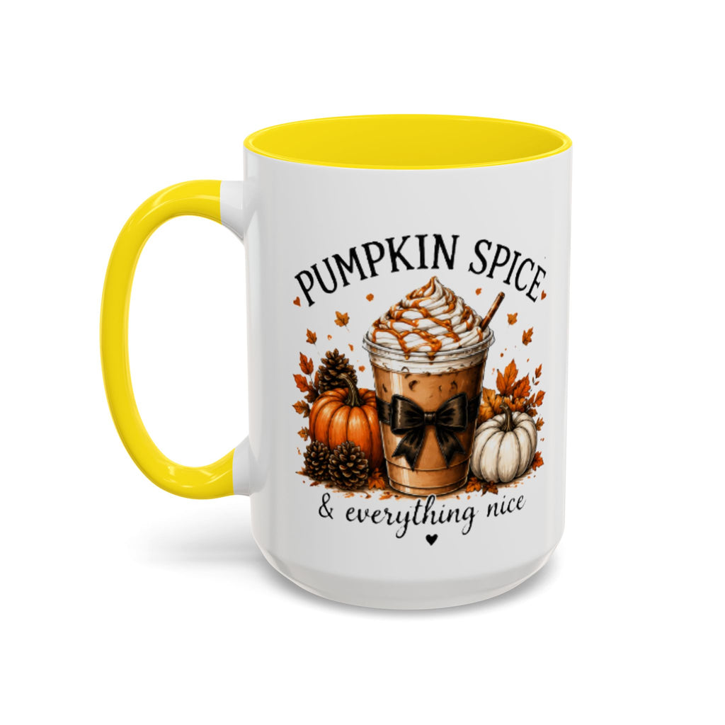 White coffee mug with yellow rim and handle, “PUMPKIN SPICE & everything nice” design.