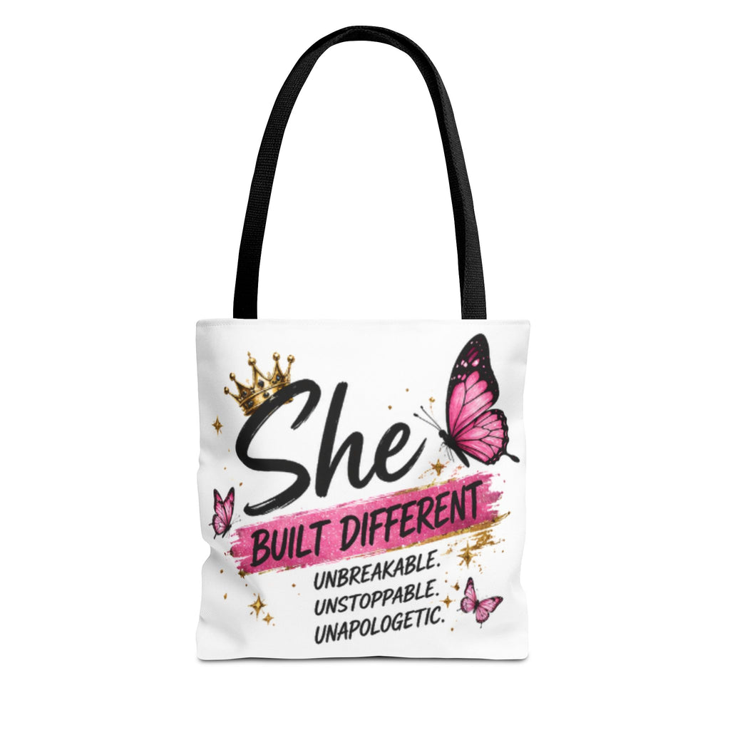 Black-strapped tote bag with 'She Built Different' lettering and pink butterfly graphic