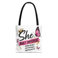 Black-strapped tote bag with 'She Built Different' lettering and pink butterfly graphic