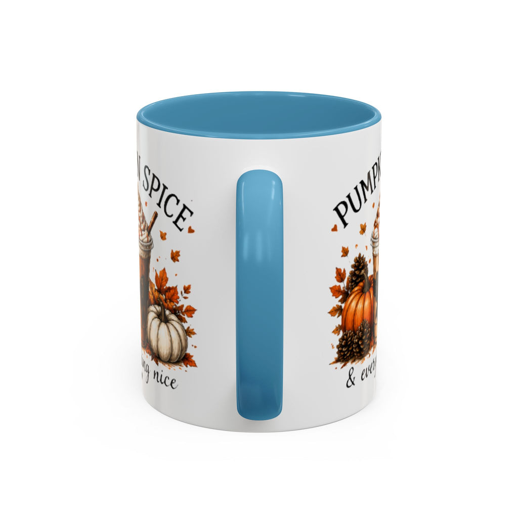 White coffee mug with light blue rim and vertical handle; pumpkin graphic on sides.