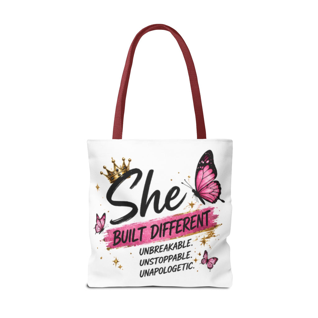 White tote bag with burgundy handles, “She Built Different” butterfly graphic front.
