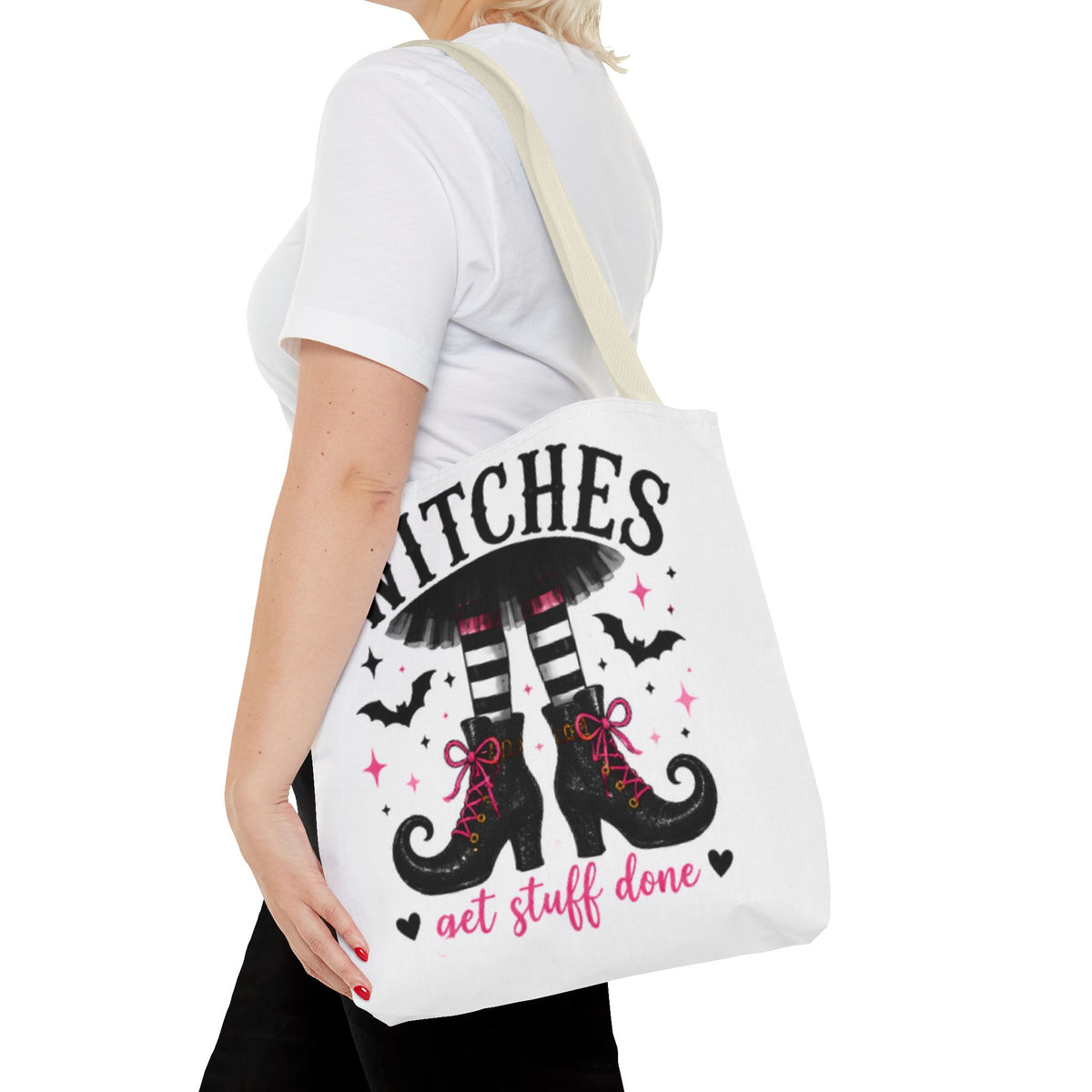 White canvas tote bag on shoulder with witch legs graphic and 'get stuff done' text