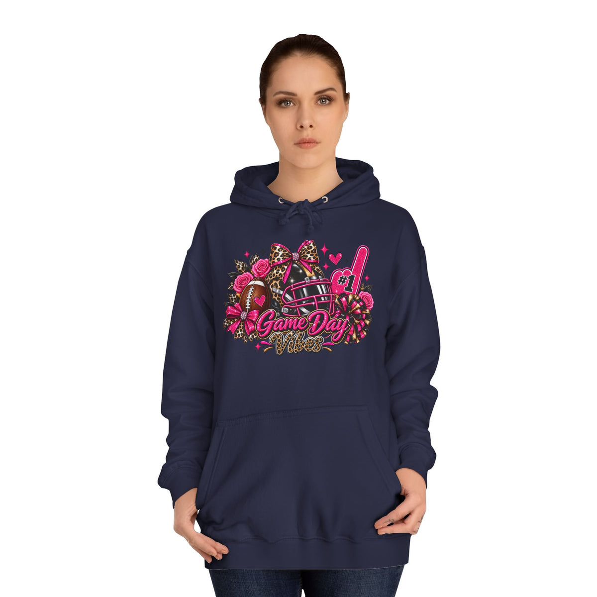Printify Game Day Cheer Hoodie — Pink Football Floral Design, navy hoodie with colorful football, bow, pom poms, and Game Day graphic modeled by a woman