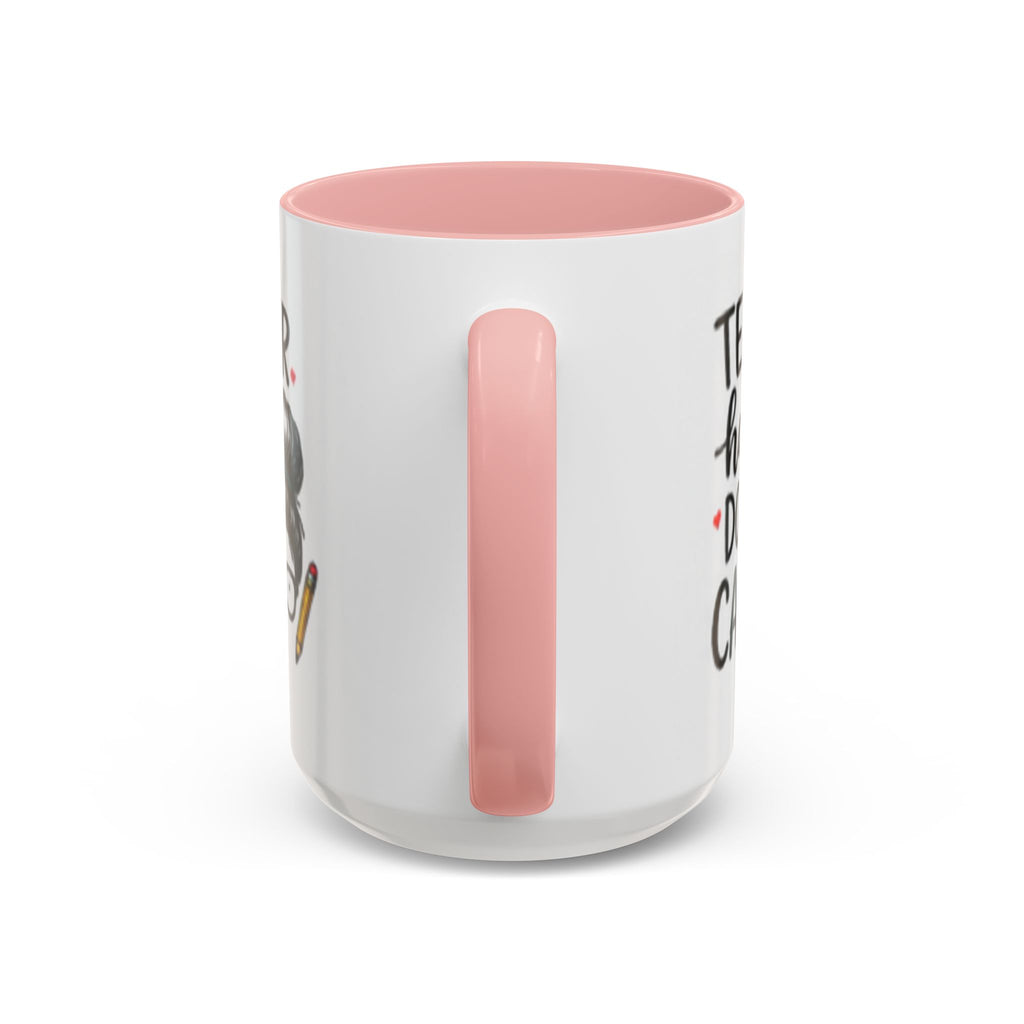 Coffee mug with pink handle and interior, featuring partial “Teacher hair don’t care” design.