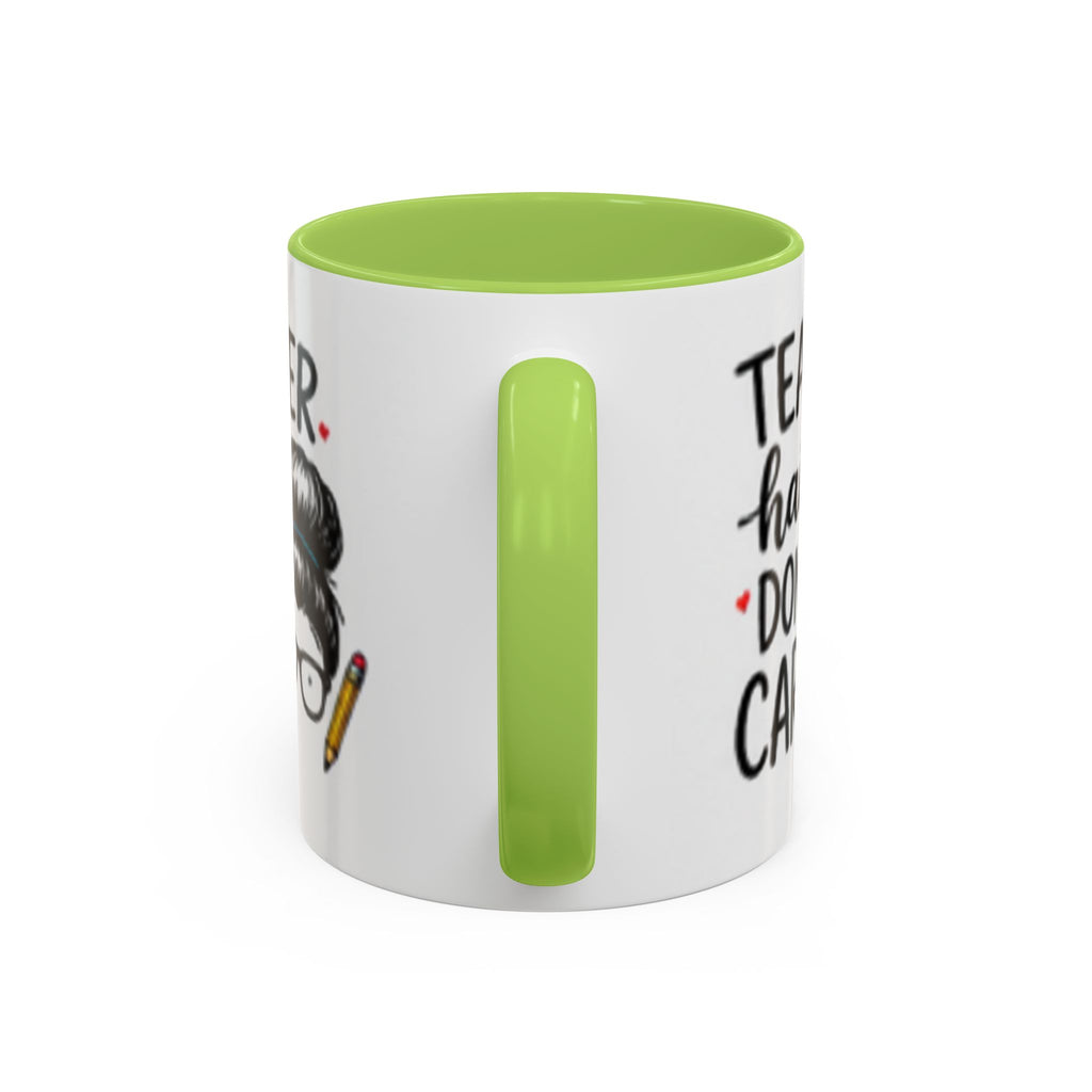 White coffee mug with green handle and partial "TEACHER hair DON'T CARE" design