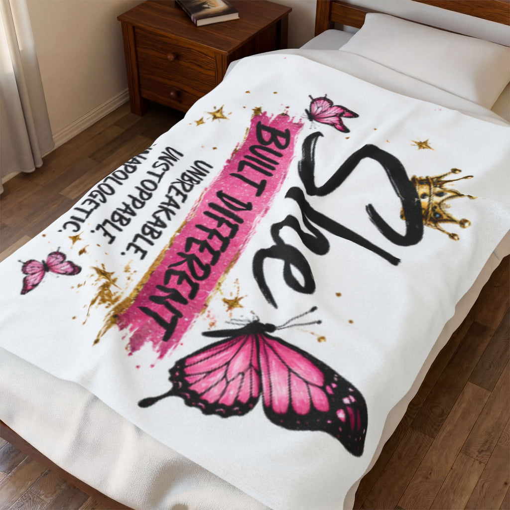 White plush blanket draped on bed with pink butterflies and bold black-pink text graphic