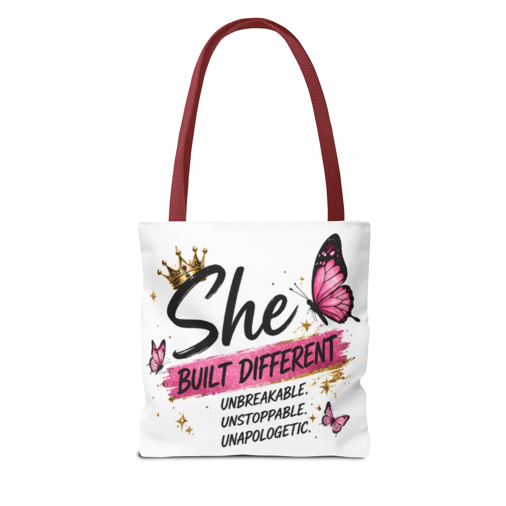 White tote bag with burgundy handles featuring “She Built Different” and pink butterflies